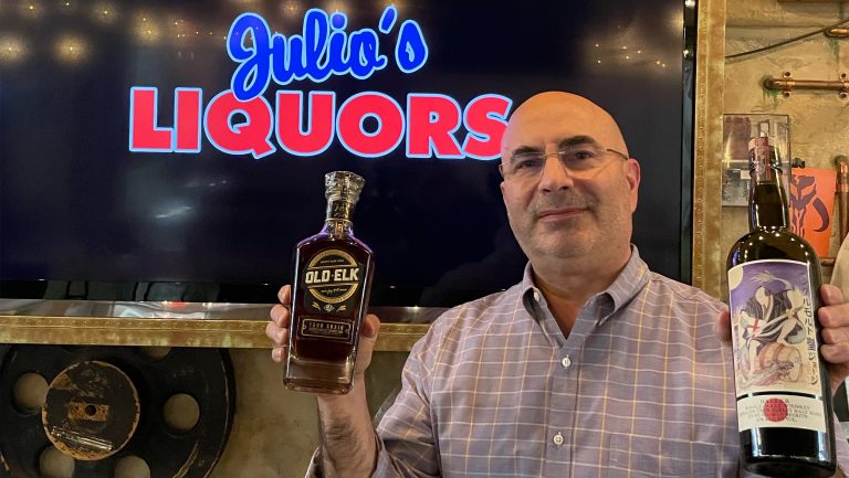 Ryan Maloney, the owner of Julio's Liquors, with Old Elk Four Grain Straight Bourbon Whiskey and St. George Spirits Baller Single Malt Whiskey. Photo courtesy of Julio's Liquors.