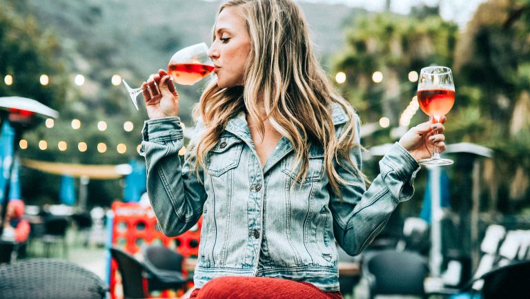Woman enjoys a couple glasses of rosé