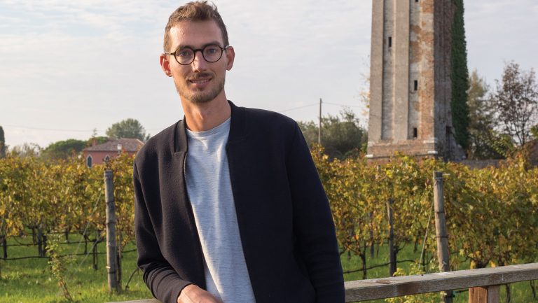 Photograph of Matteo Bisol of Venissa in front of a vineyard