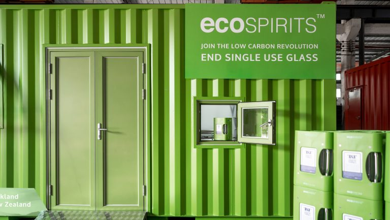 A bright green ecoSpirits branded shipping container
