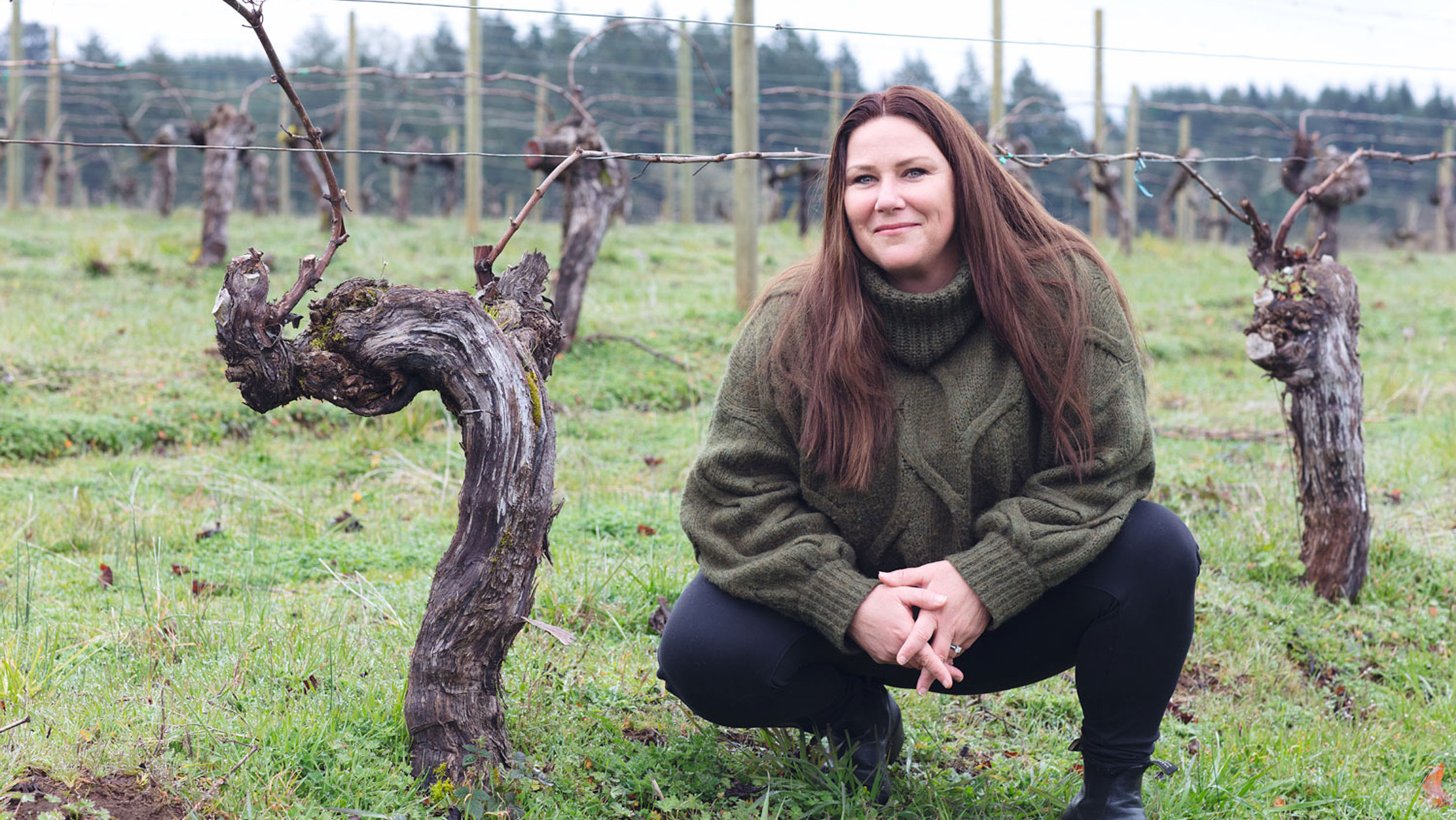 Winemaker Bree Stock of Limited Addition poses next to a vine