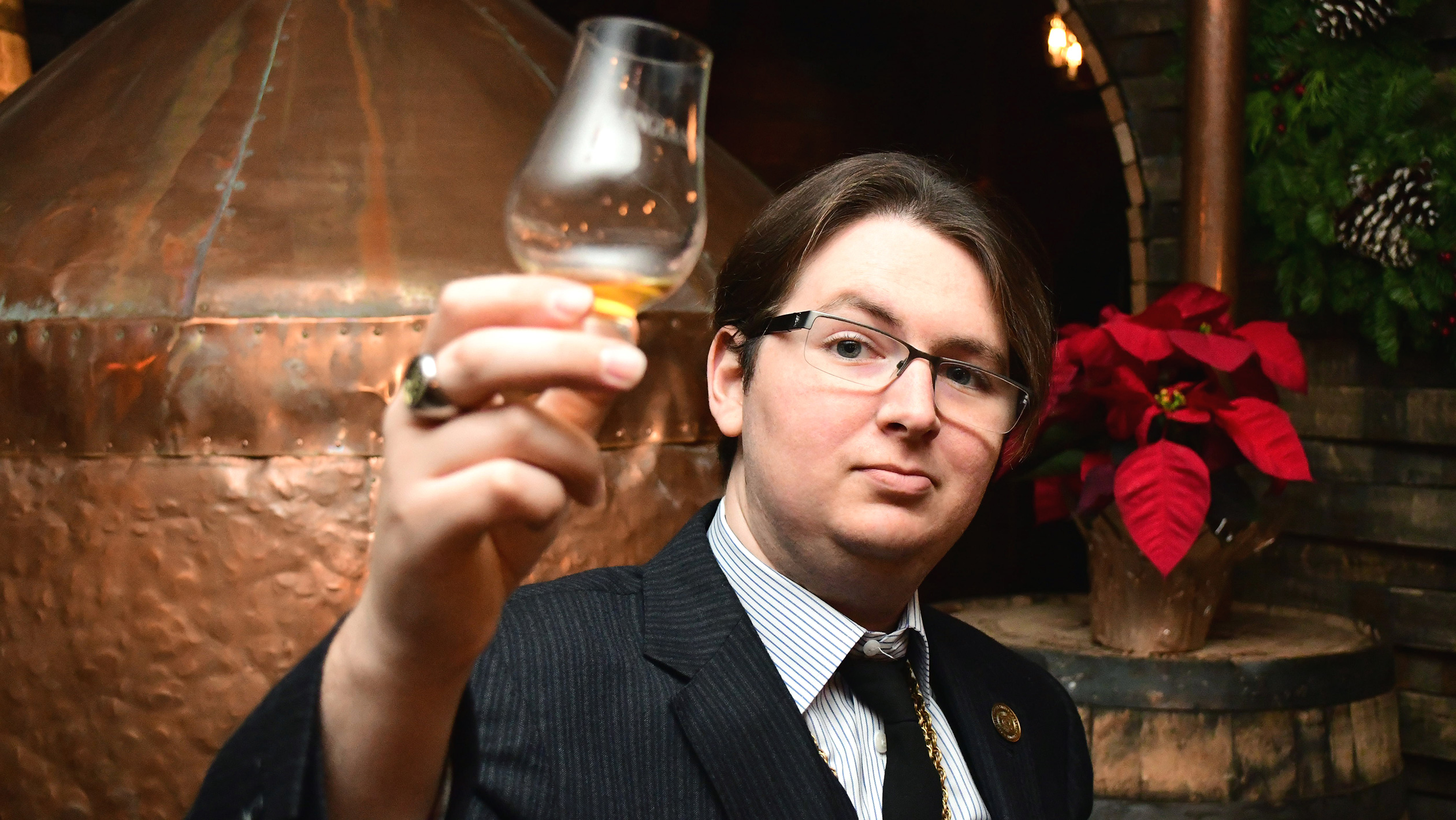 Sam Knash Green examines a sample of whiskey