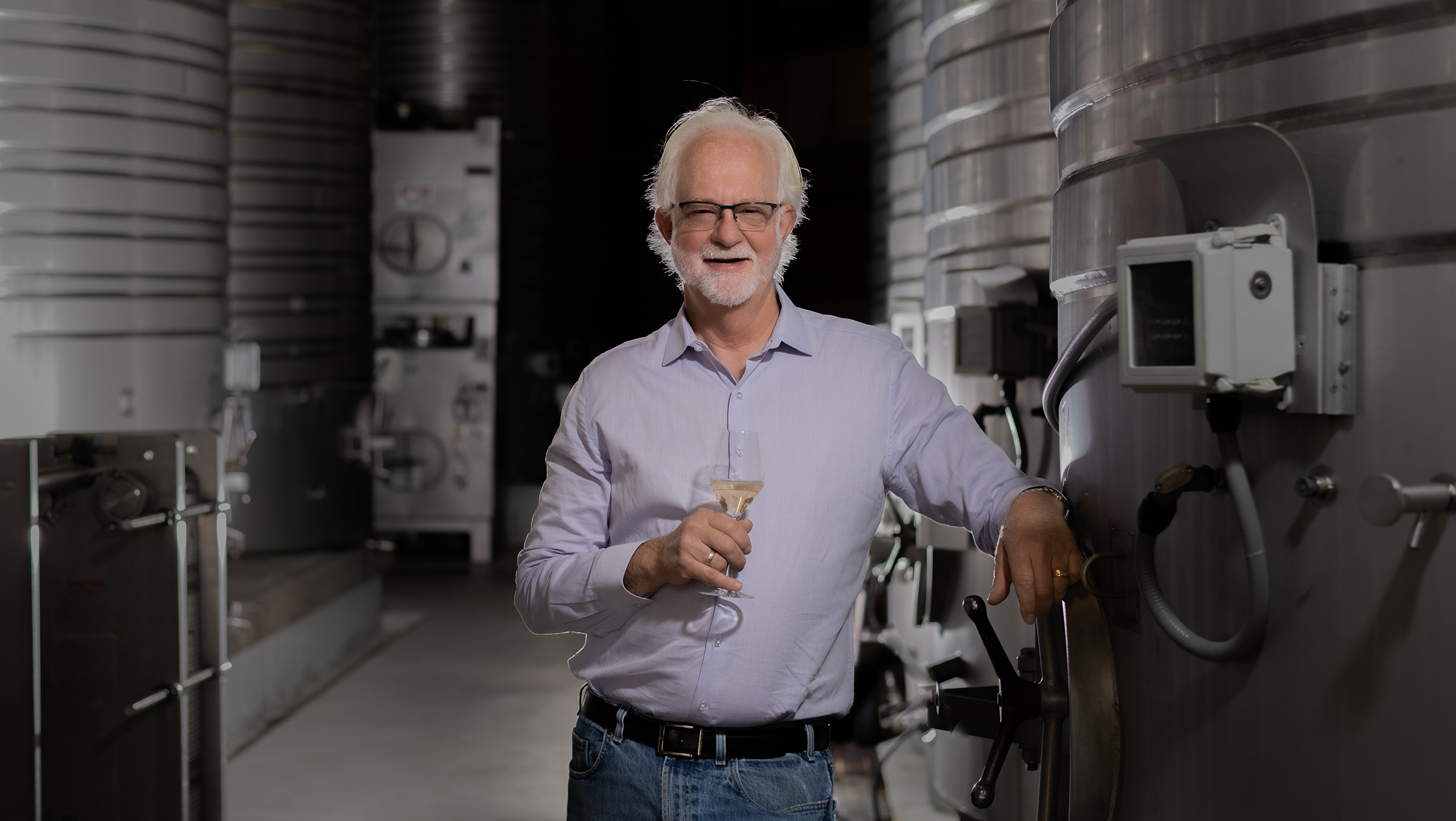 Harry Hansen poses in a winemaking facility