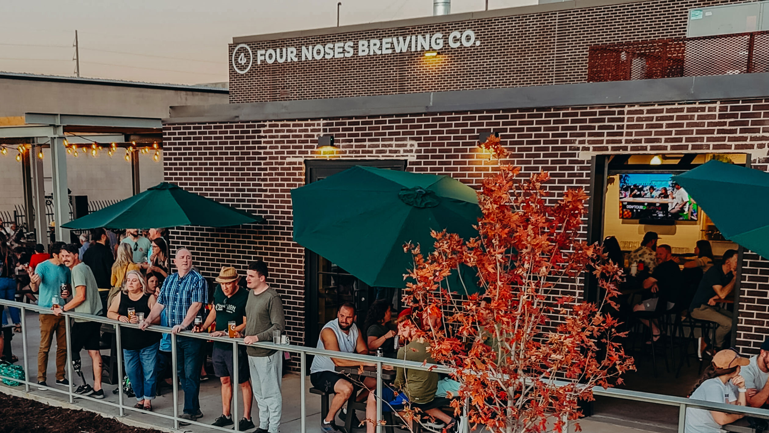 Consumers gather in an outdoor seating area at 4 Noses Brewing.