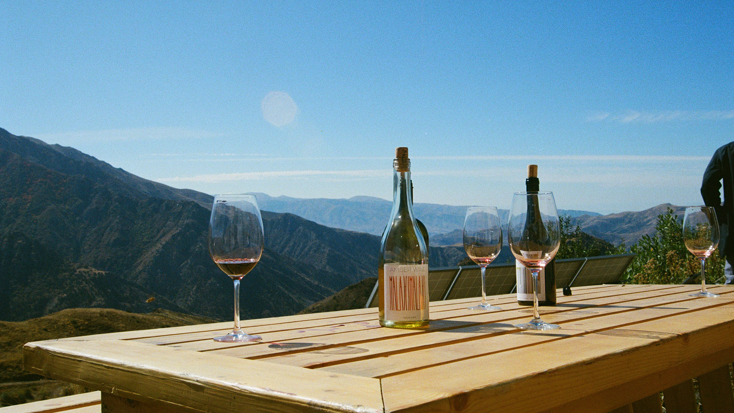 A view of Armenian mountains from an outdoor table laid with Maran wines