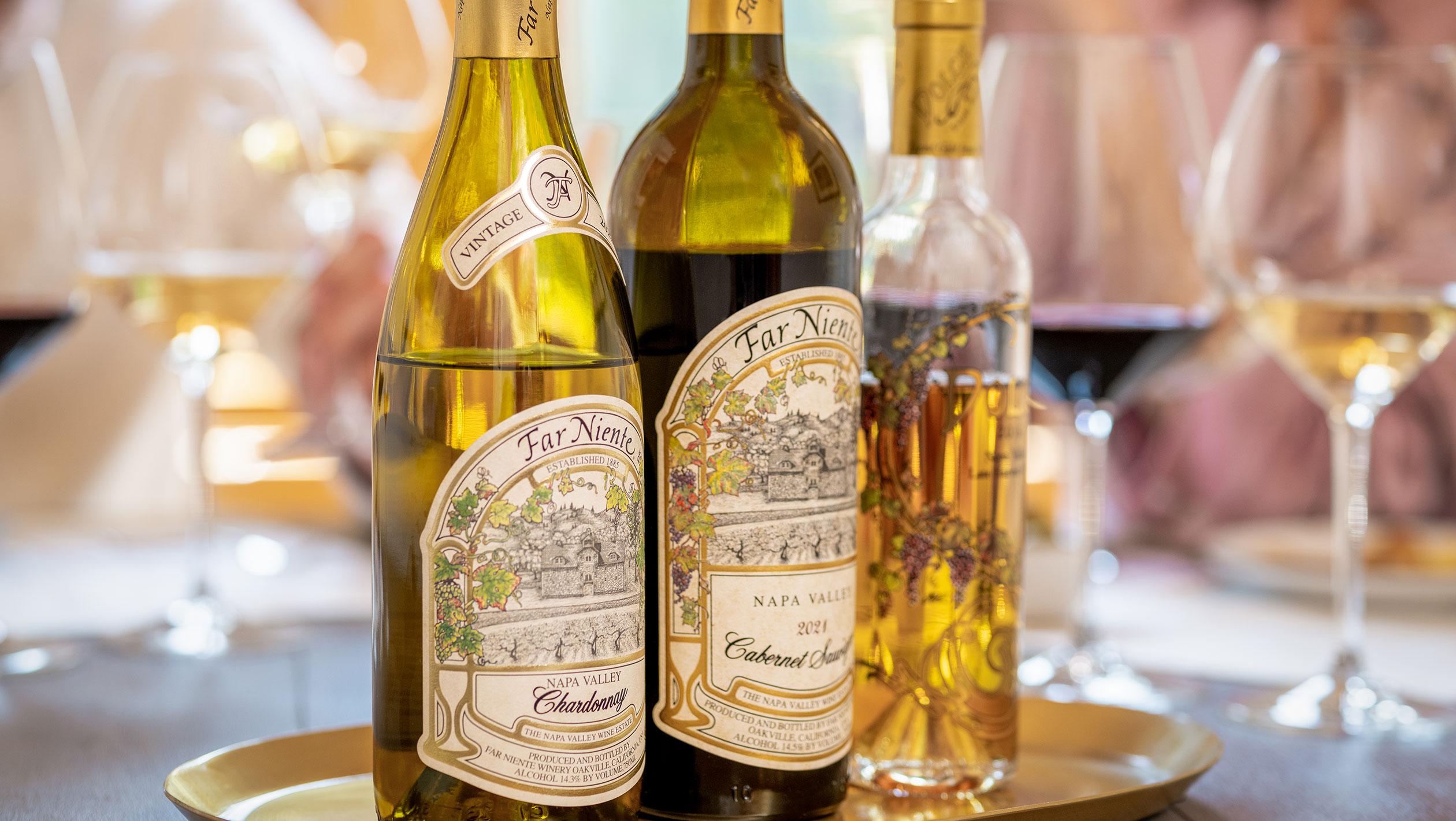 A closeup of three Far Niente wine bottles