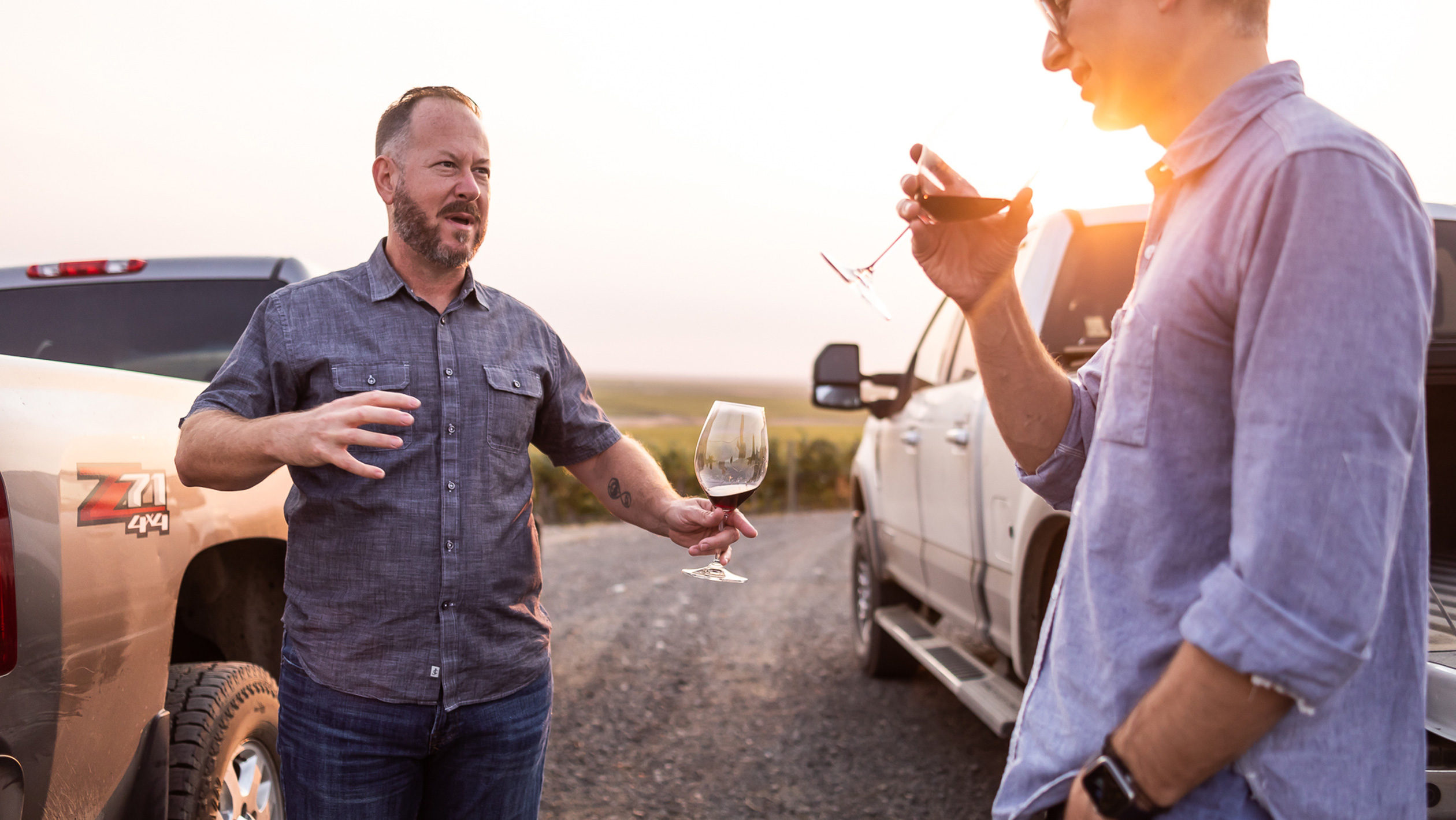 Jeff Andrews and Ray McKee have a conversation over some samples of red wine