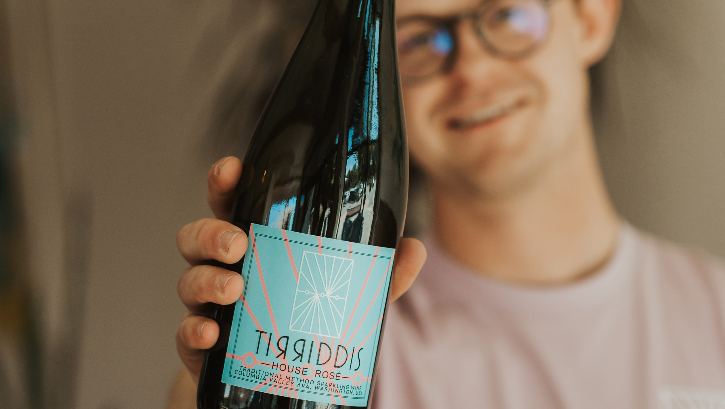 Andrew Gerow, cofounder of Tirriddis, poses with a Tirriddis bottle in the foreground.