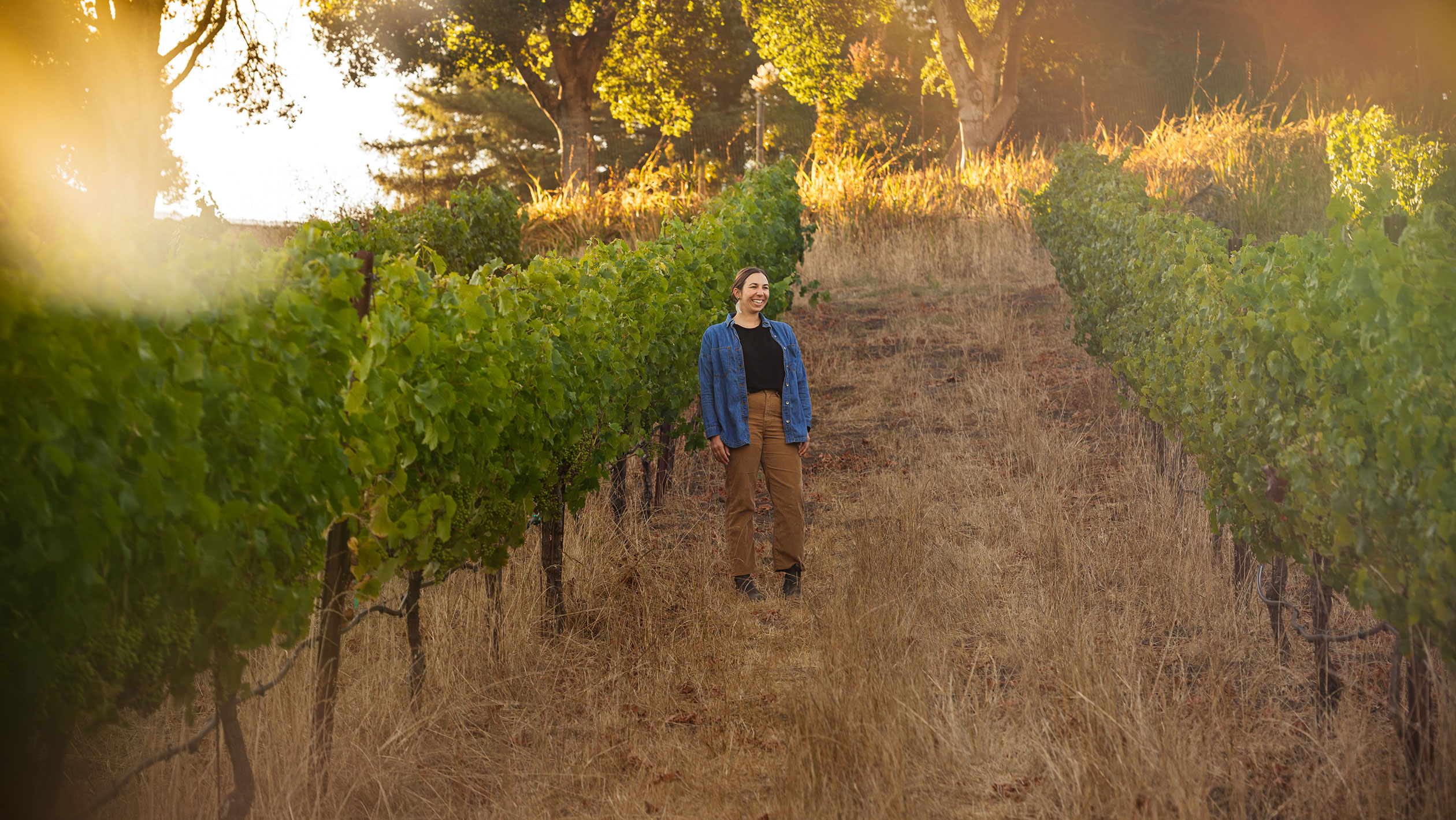 Megan Bell poses in a vineyard