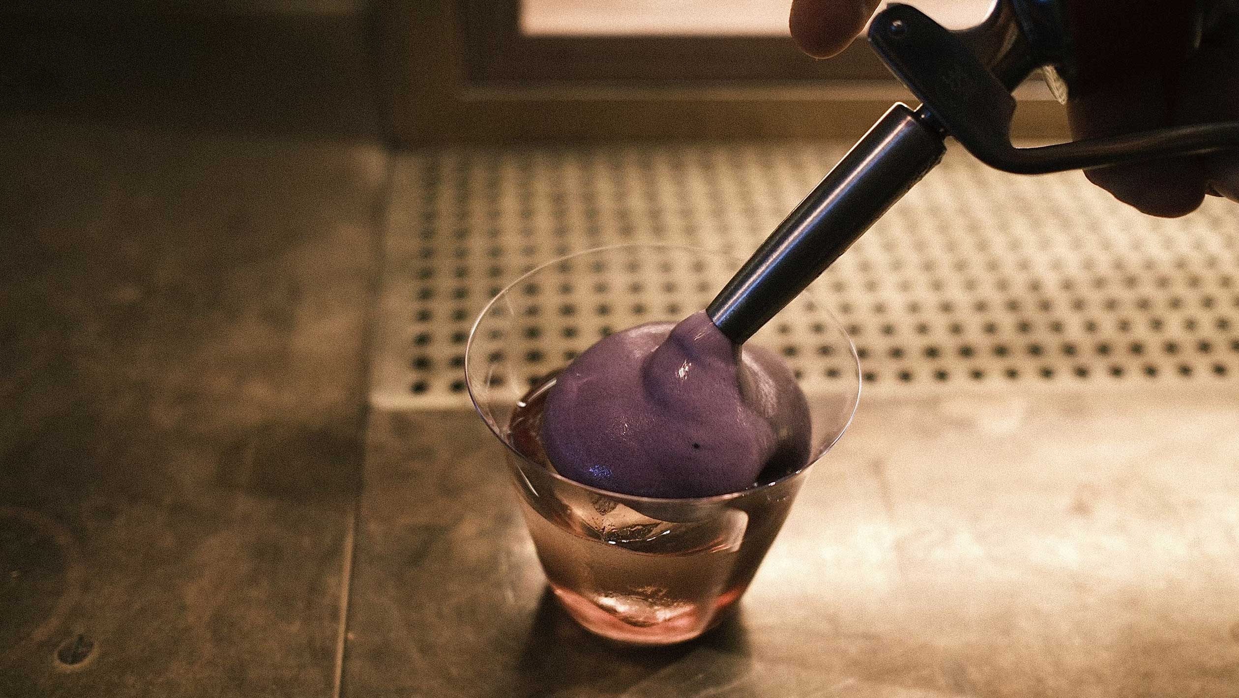 A layered cocktail with a purple top