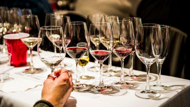 numerous glasses of wine on a table