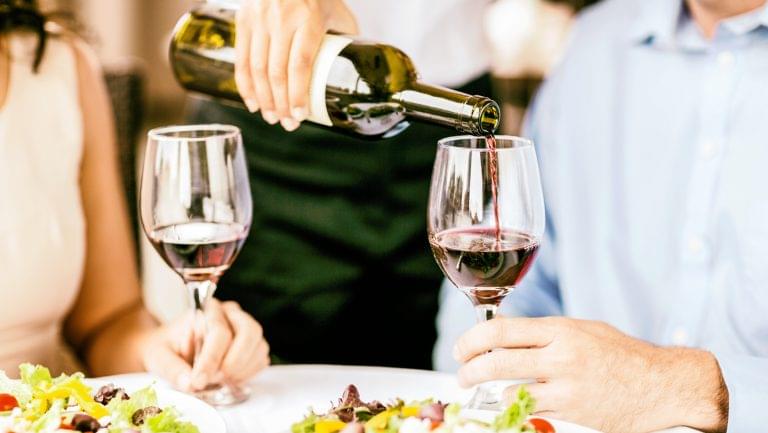 two people socializing with wine