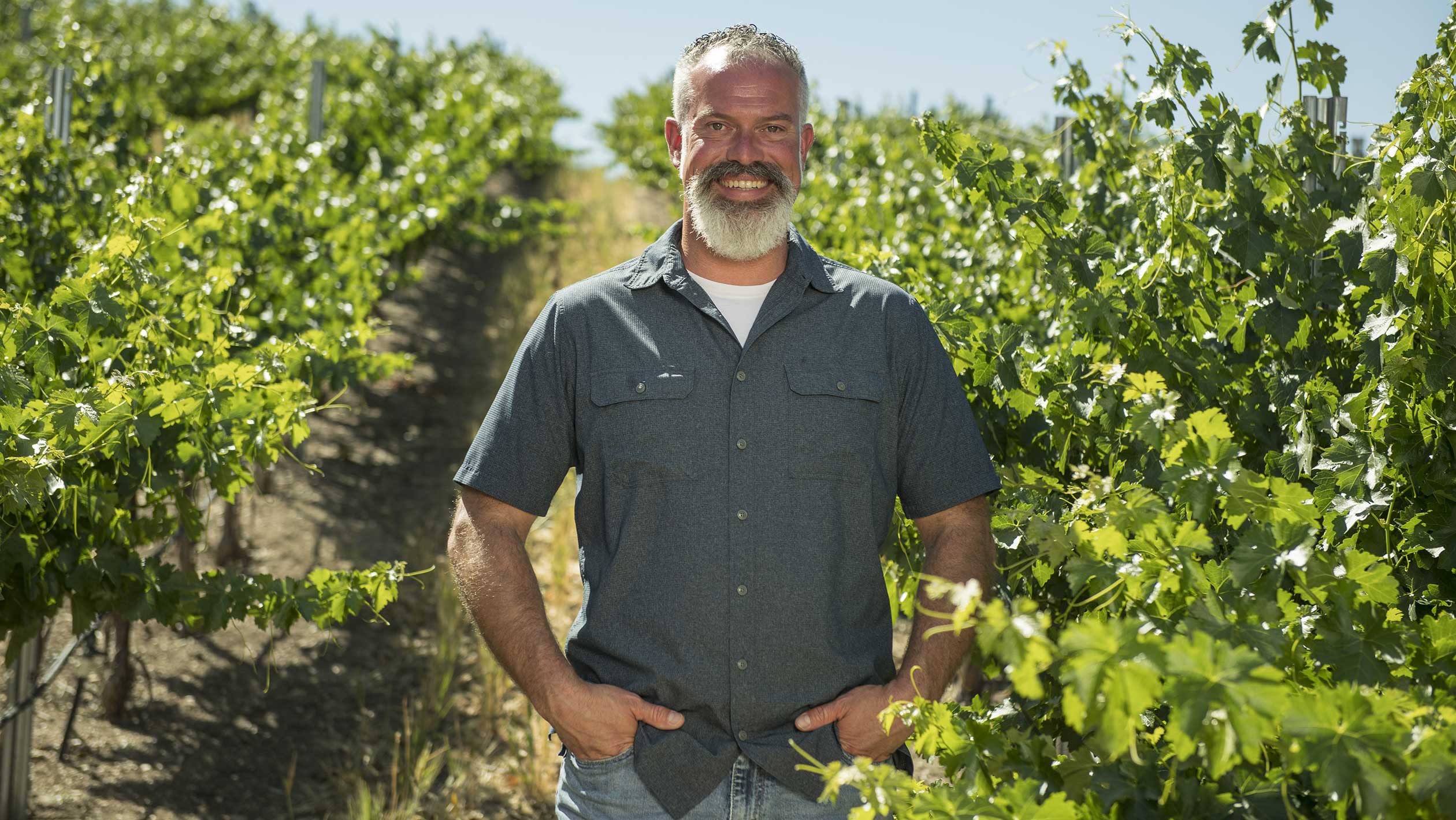 A photo of Marty Spate posing in a vineyard