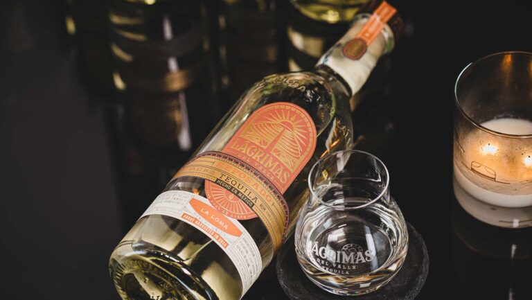 A bottle of Lagrimas del Valle's La Loma Reposado with a glass. 