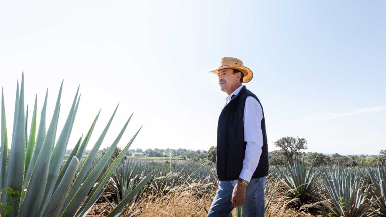 Carlos Camarena, a fifth-generation agavero and the master distiller and cofounder of Tequila Ocho, stands in an agave field in Mexico.