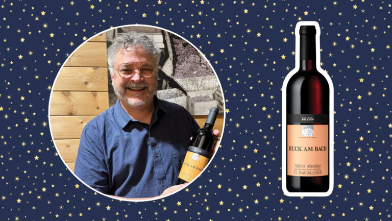 A photo of Ole Thompson, the wine director of Esquin Wine & Spirits and a bottle of Cantina Bolzano ‘Huck am Bach’ Santa Maddalena Classico 2023. 