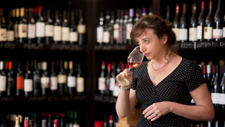 A photo of wine-sense owner Samanta Ettore smelling a glass of wine.