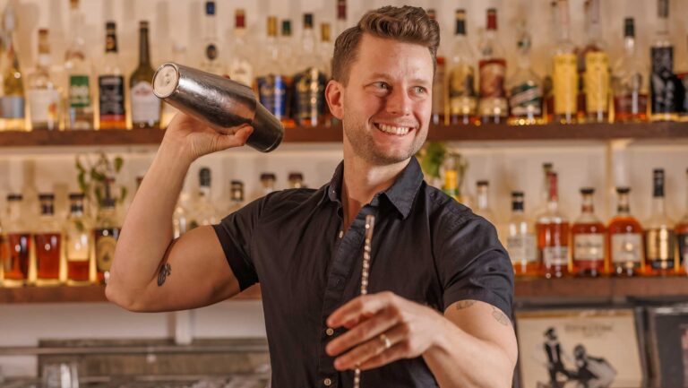 Stuart Weaver, the owner and general manager of Lady Jane, shaking a cocktail tin.