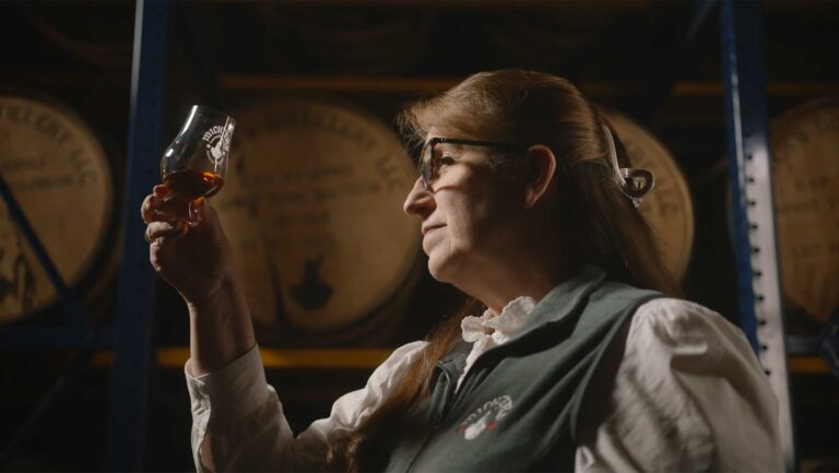 Andrea Wilson, the master of maturation and chief operating officer at Michter's Distillery examining a glass.