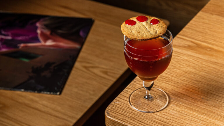 Several of the cocktails at Press Club in Washington, D.C., come with added bites, such as their Manhattan variation, which is served with a sugar cookie. Photo by Rey Lopez.